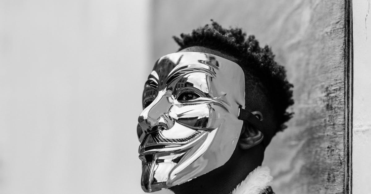 Changes to British transit visa policy - Black activist wearing Anonymous mask as sign of protest