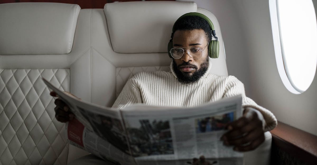 Changing a passenger on a Lufthansa flight - A Man with Eyeglasses Reading a Newspaper