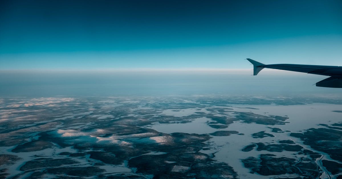 Changing dates for part of a flight - Airplane flying over wetland in evening