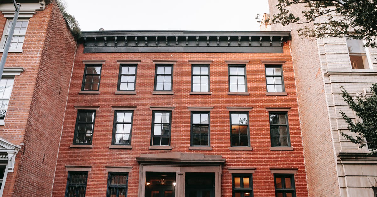 Changing from single entry to multiple entry visa - Facade of brick house with black window frames