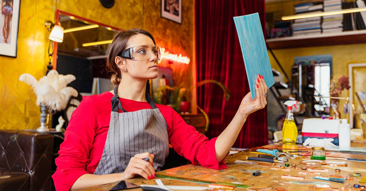 Changing passport details for a flight? - Woman in Goggles Sitting at Table and Making Art Details