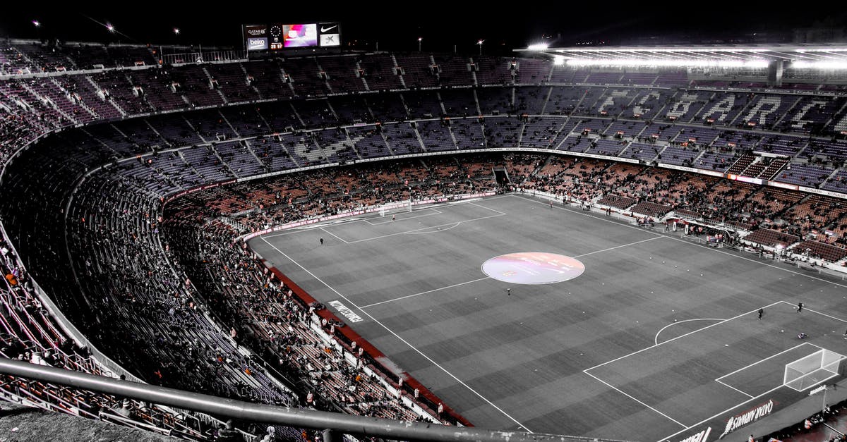 Changing status from Tier 4 to visitor - Modern football stadium with spectators on tribunes