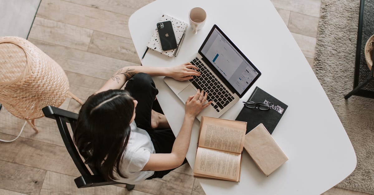 Changing UK visa from visitor to study - Young lady typing on keyboard of laptop in living room