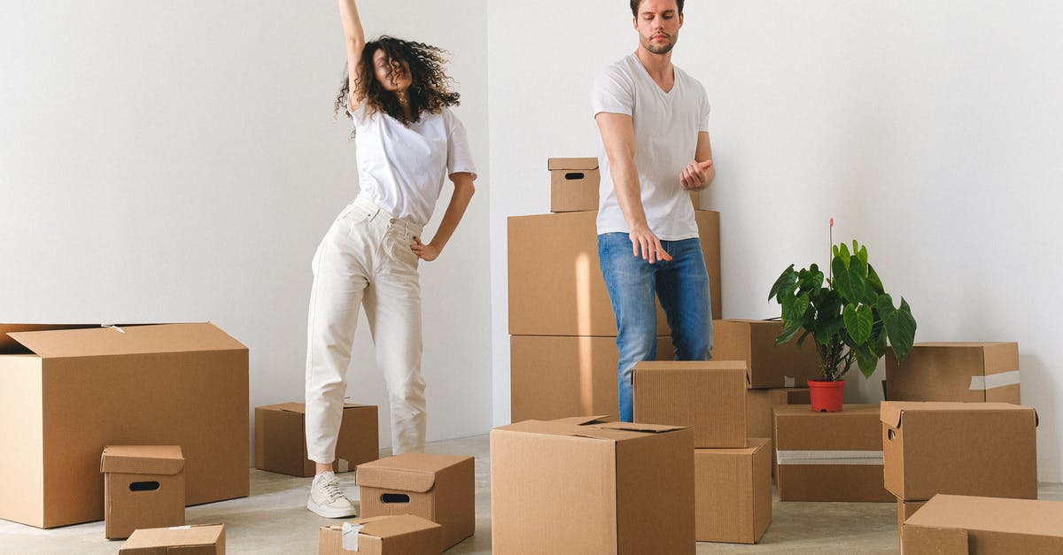 Cheap accommodation in London [closed] - Joyful young couple dancing after moving in new purchased apartment