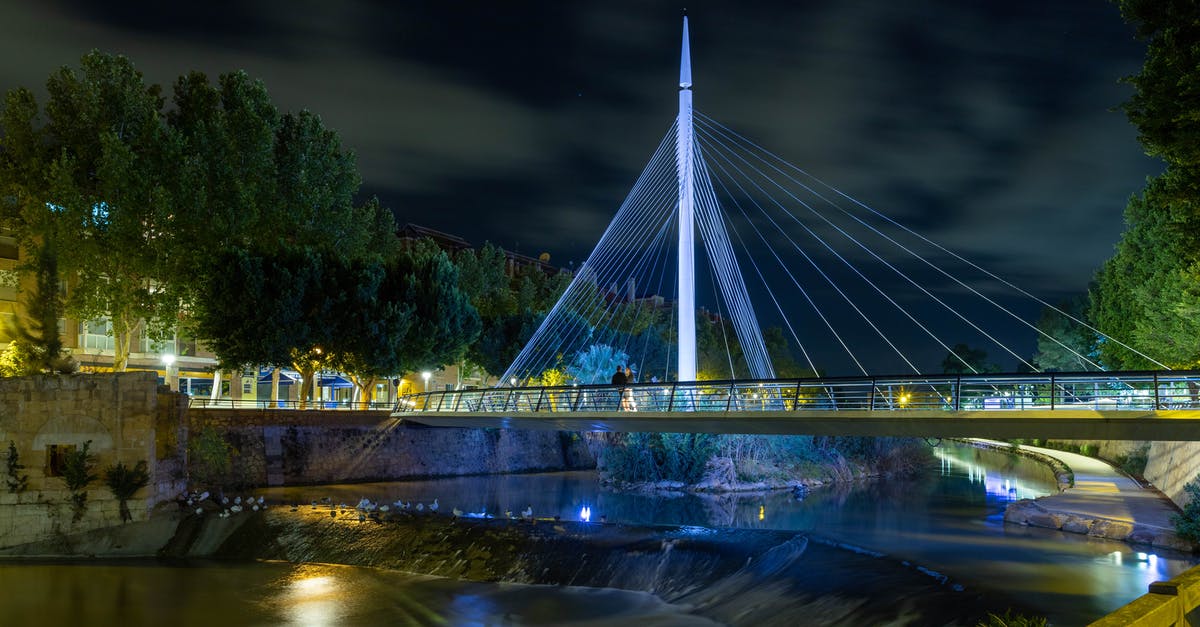 Cheap accommodation in Spain - White Bridge over River during Night Time