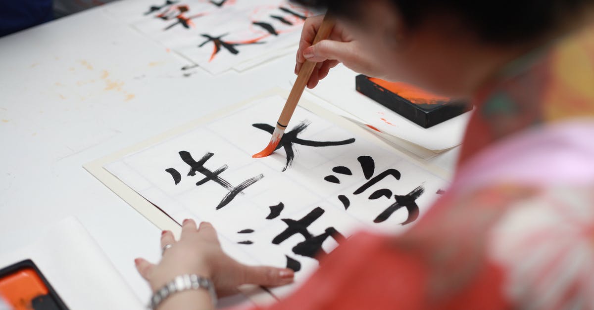 Cheap flights in South-East Asia [closed] - Person Holding Brush Drawing Kanji Script