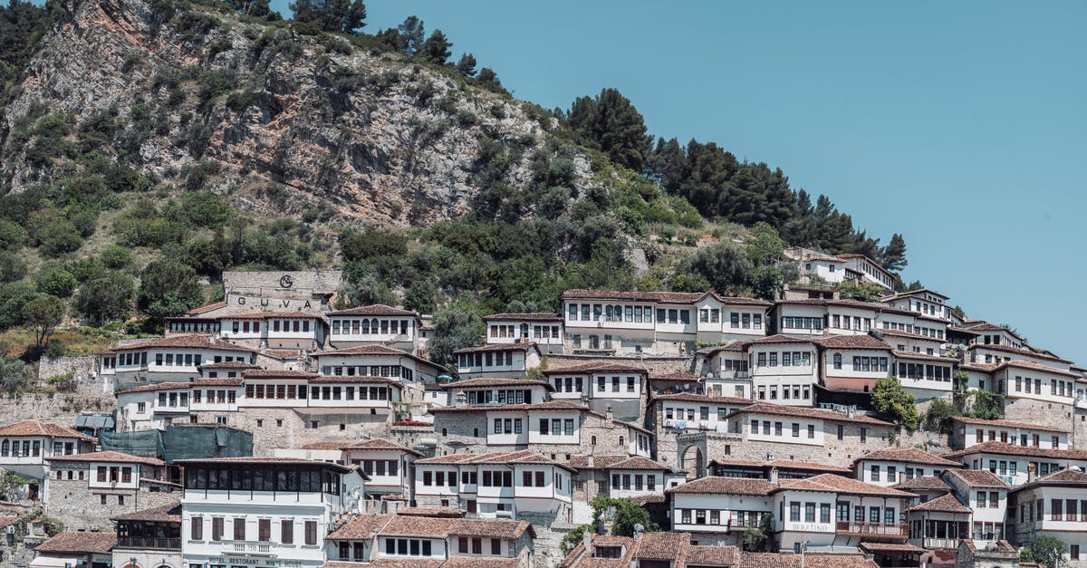 Cheap last-minute flights in Europe - White and Brown Concrete Building Near Green Trees