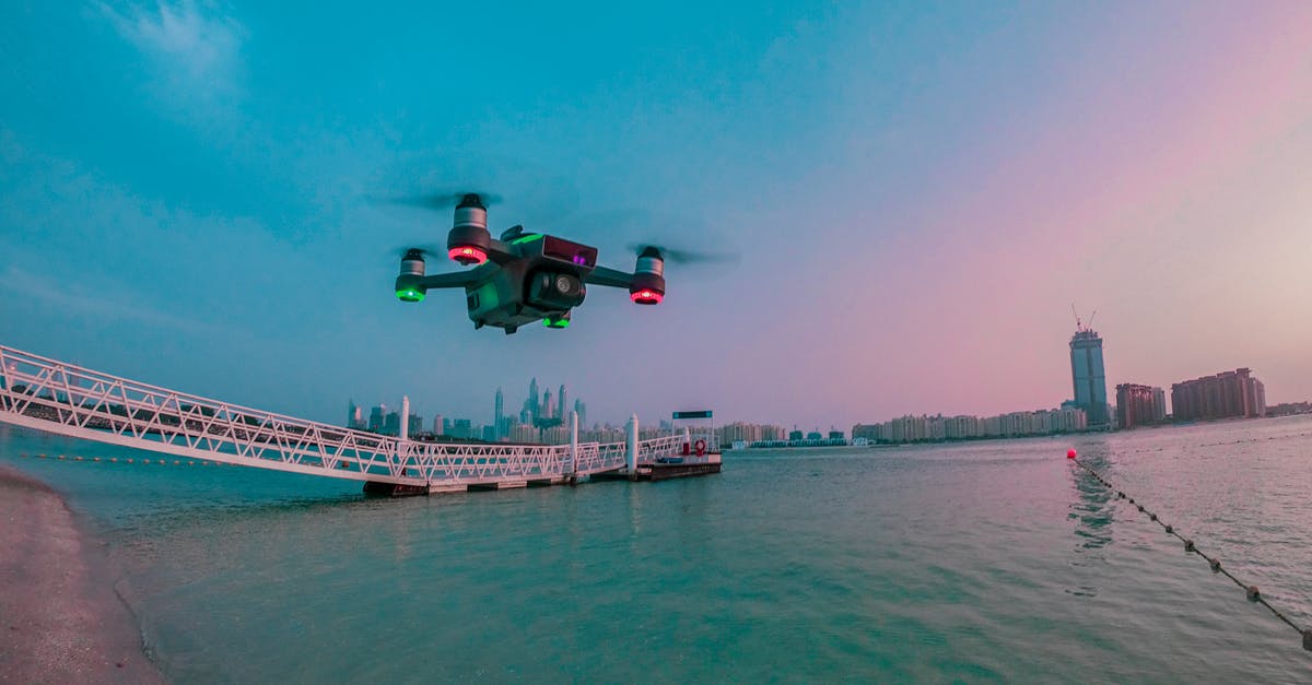 Cheapest flight "from any city" - Modern drone filming video while flying above city river