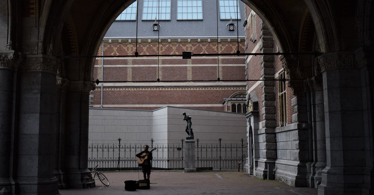 Cheapest option to get a bike for a week Amsterdam - Person Playing Guitar on Street