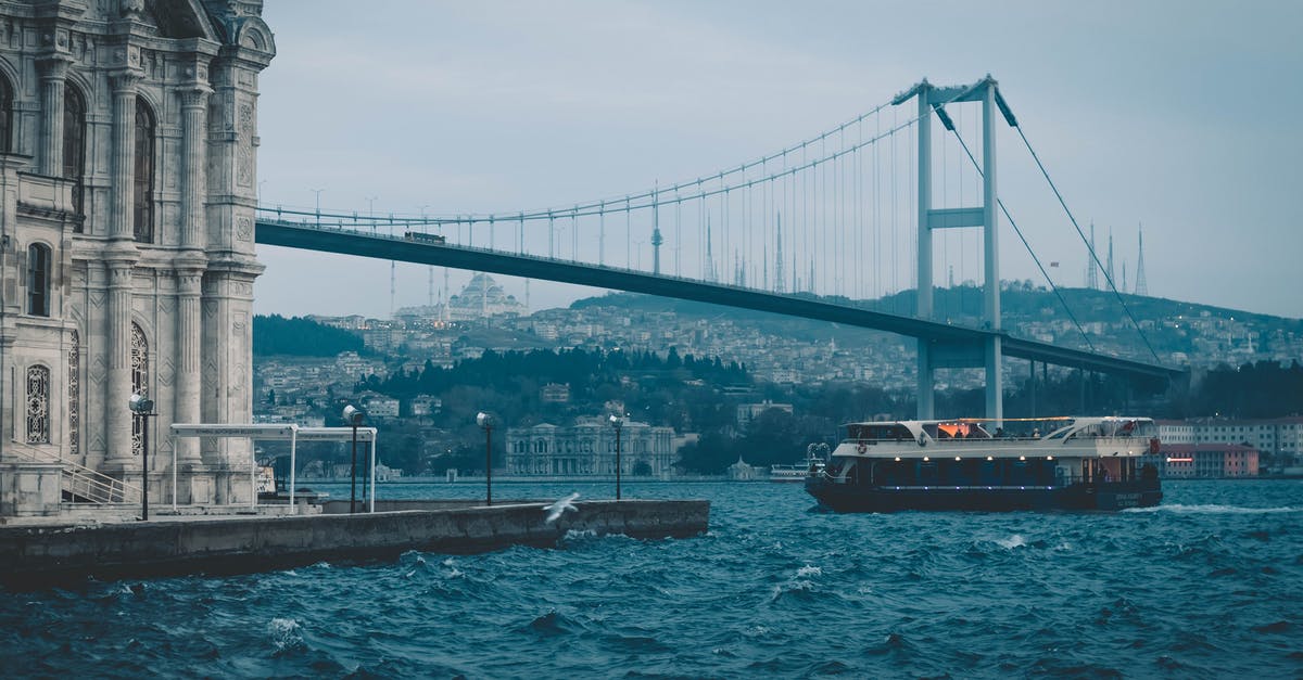 Cheapest transport to go to Istanbul from Van(Turkey) - Cruise boat floating on river near suspension bridge and old mosque