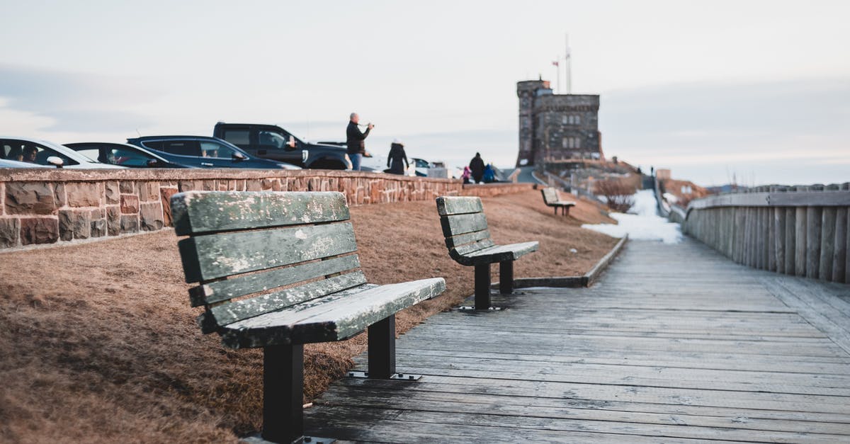 Cheapest way of shipping my car from Canada to Europe? - Wooden footpath with old benches near tower at sunset