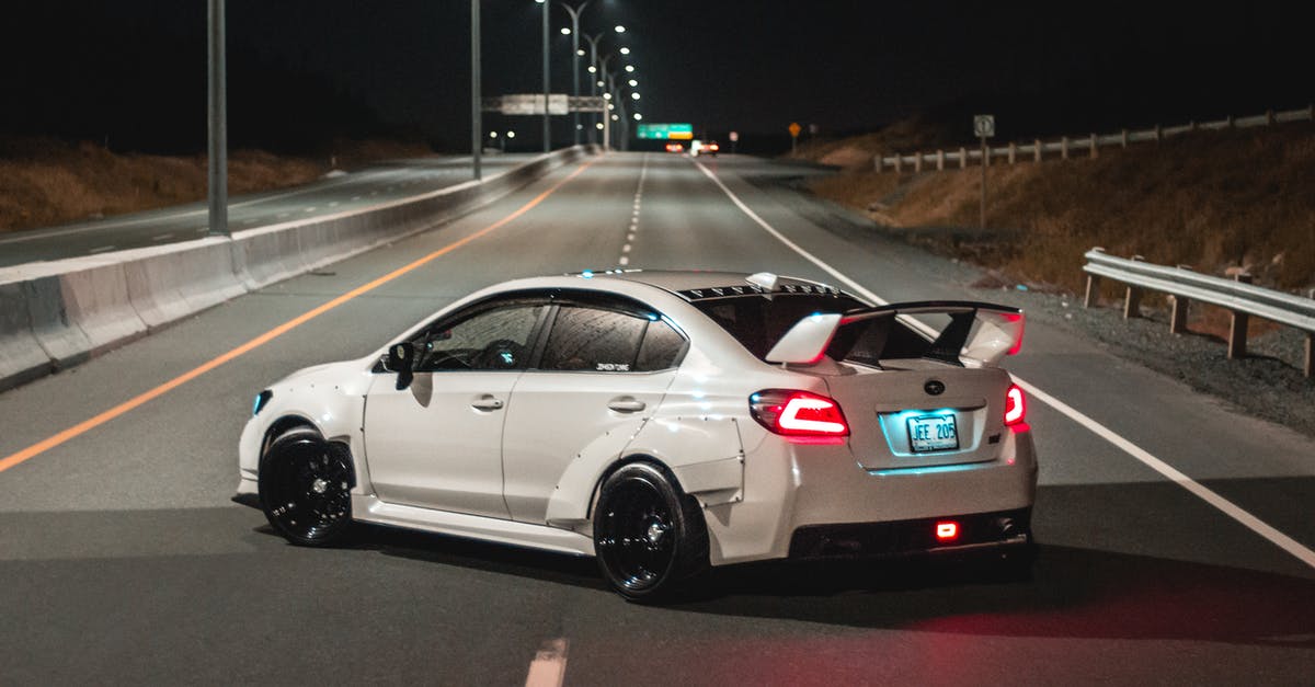 Cheapest way to get around in Tokyo - Sports car turning around on road at night