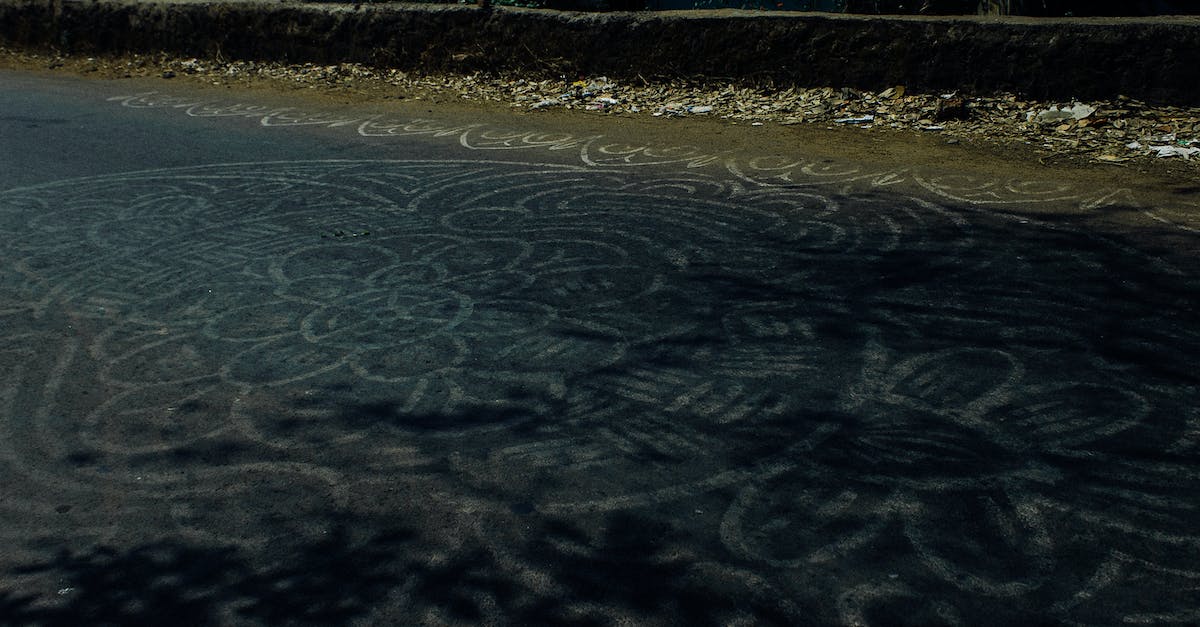 Cheapest way to get HON circle status? - Pale white abstract mandala ornament painted on asphalt road in rural area in daylight