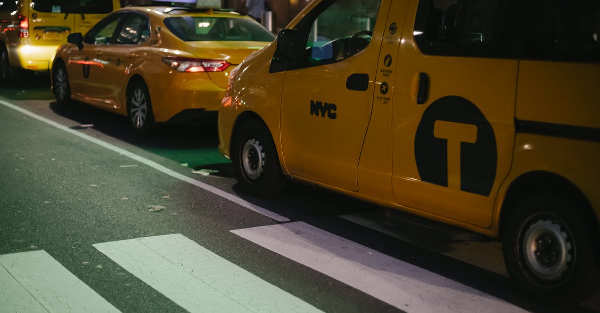 Cheapest way to sleep in central Tokyo? - Modern various yellow taxi cars parked on street at night in New York City