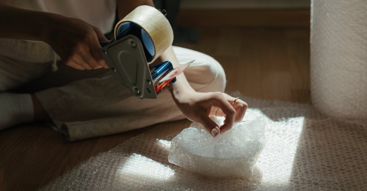 Checked baggage bubble wrapped only - Person Holding White and Black Vr Goggles