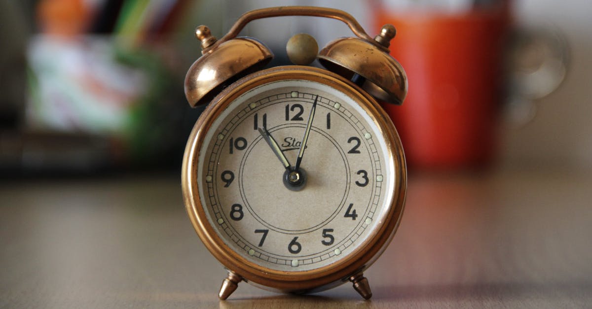 Check-in time for early morning flight from Minneapolis–St Paul - Focus Photography of Brown Double Bell Alarm Clock