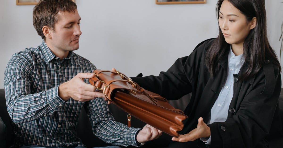 Checking bags internationally - A Woman Looking a Leather Briefcase