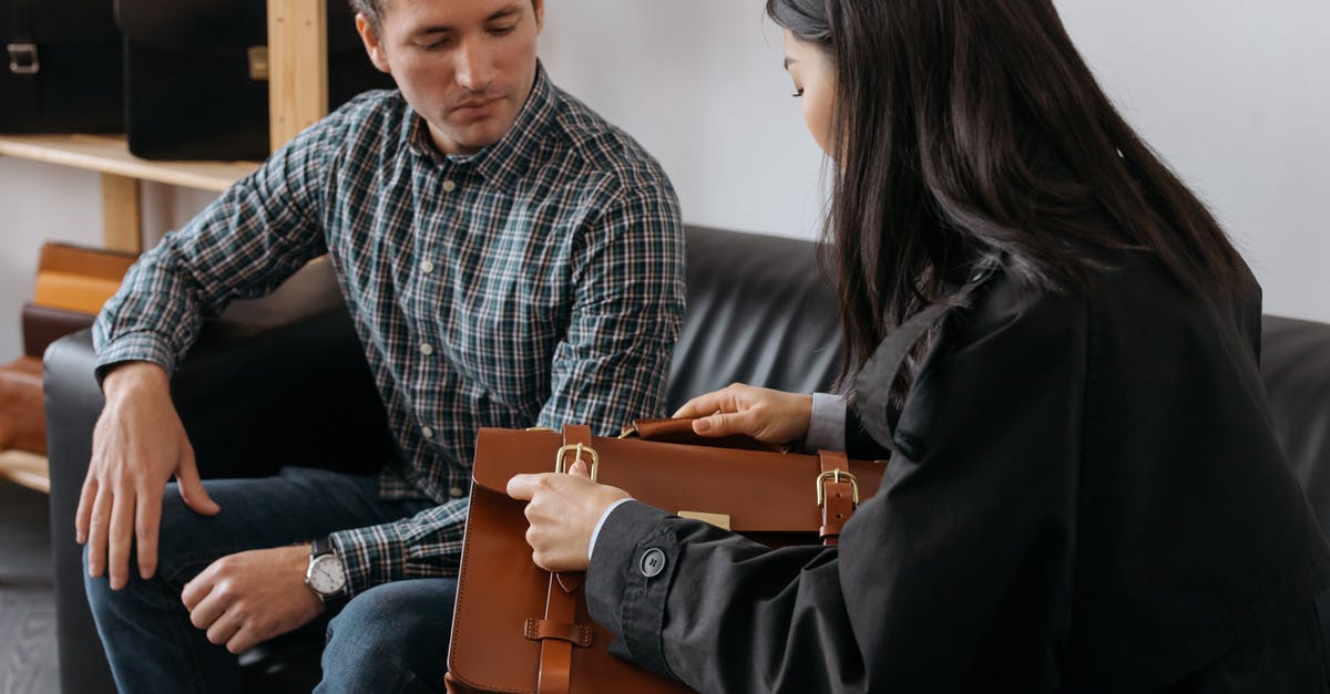 Checking bags internationally - A Woman Checking a Brown Leather Briefcase