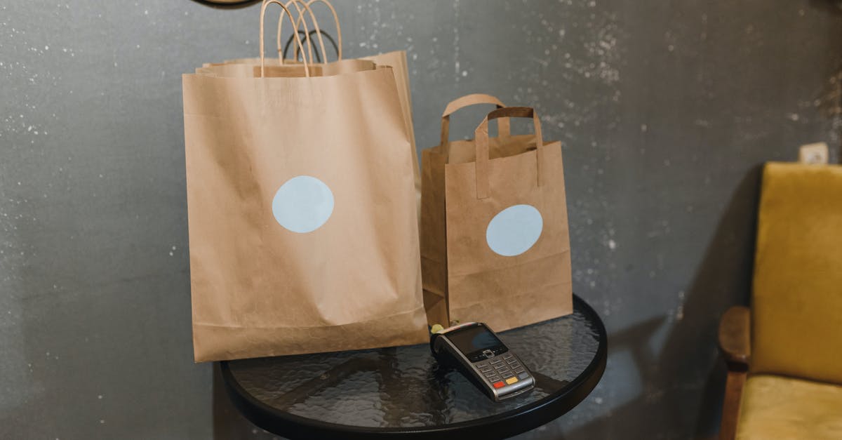 Checking in bags early - Brown Paper Bag on Round Black Table