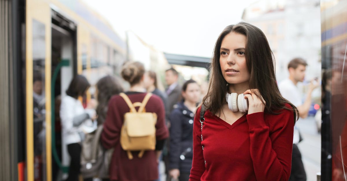 Checking luggage all the way through? - Young woman standing on train platform