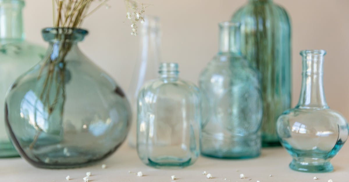 Checking small items on a plane? - Three Clear Glass Bottles on White Table