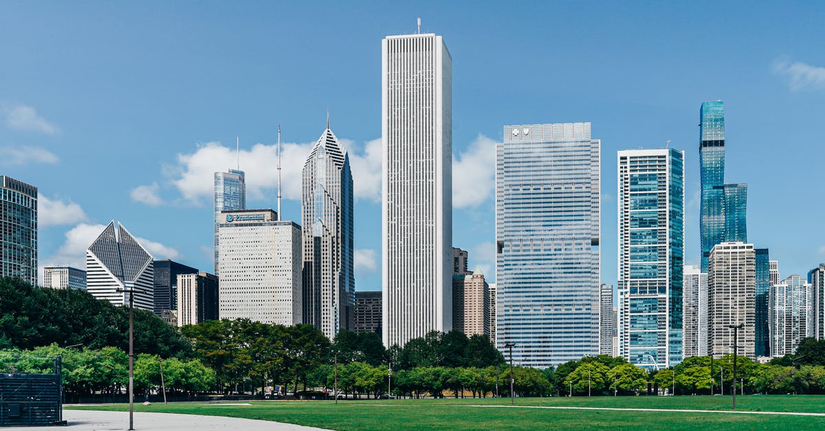 Chicago United Center to Midway Airport - Modern city district with skyscrapers near green lawn