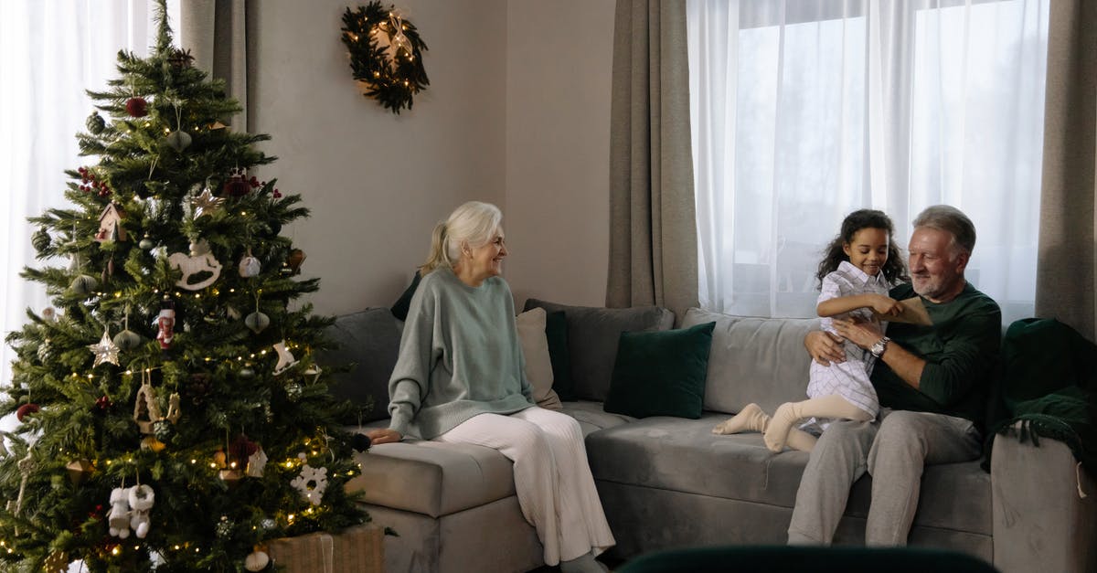 Child age for Virgin Atlantic flights - Woman in Gray Sweater Sitting on Gray Couch