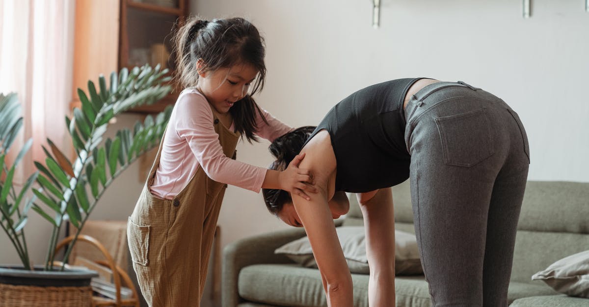 Children free under 5 on UK trains -- any need to prove? - Young flexible ethnic woman with cute daughter during workout together