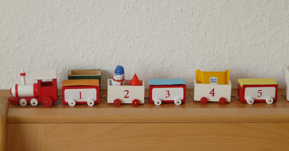 Children joining train later UK - Plastic Toy Train on Wooden Rack