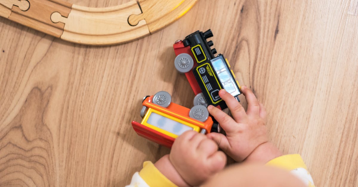 Children joining train later UK - Person Holding Red and Black Toy Car