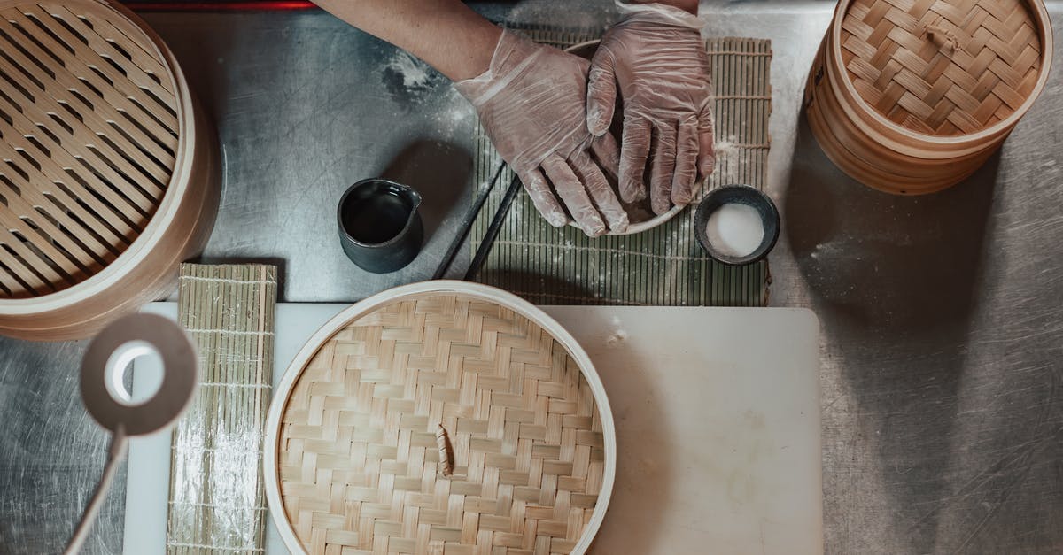 Chinese citizen/passport making connection flight in Zurich [duplicate] - Person in Gloves Cooking on the Table Beside Bamboo Baskets