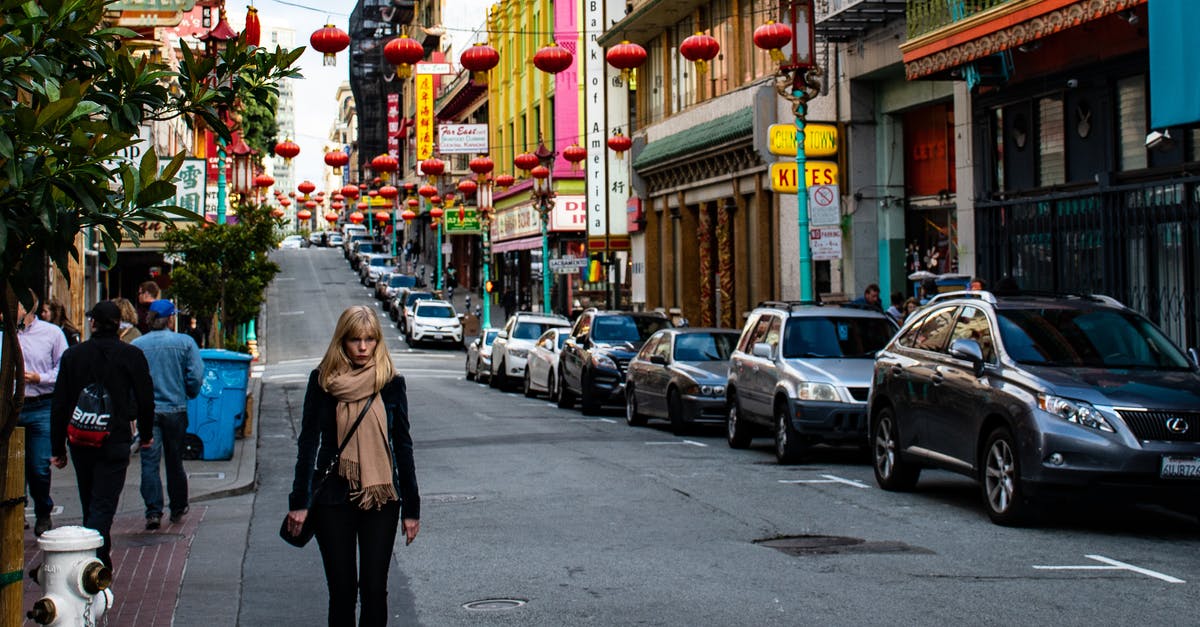 Chinese VISA Q2 10 year - Tourist to Work - Woman Wearing Black Jacket Walking on the Road