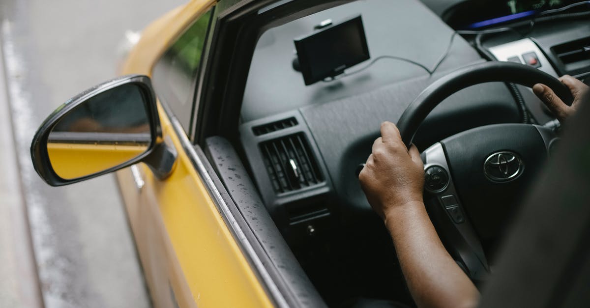 Choosing between 2 google map routes - Faceless person driving contemporary cab in city