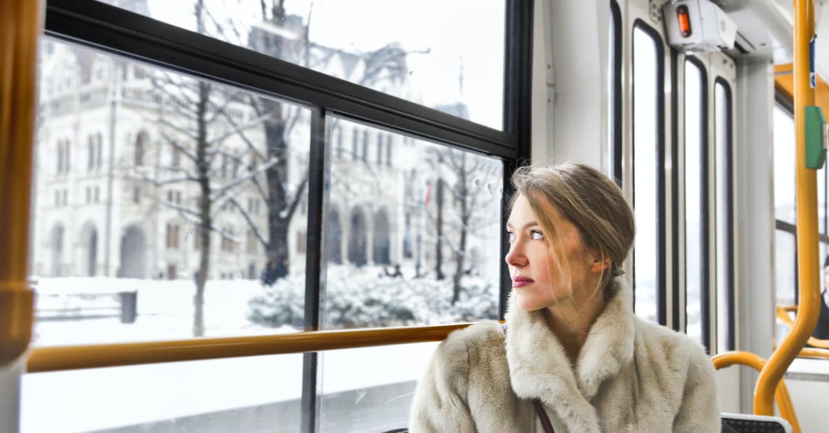 Choosing seat in DB IC bus - Cam young woman in warm clothes in public transport