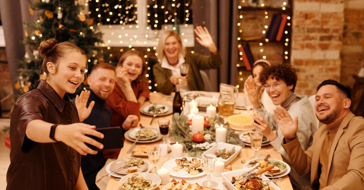 Christmas Dinner in Foreign Country - Family Celebrating Christmas Dinner While Taking Selfie