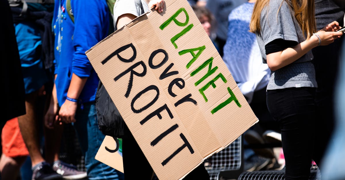 Circular signs with blue edges - Woman in Blue Jacket Holding White and Black I Am Happy to Be Happy Print Paper