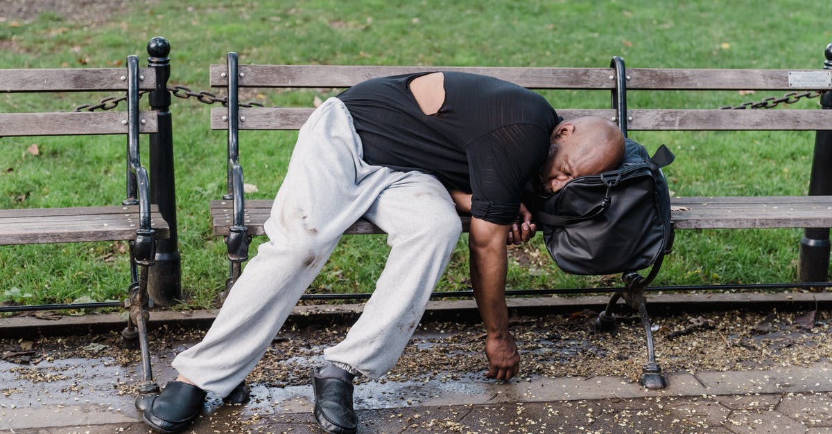 Cities close to Stockholm to visit in a day [closed] - Man in Black T-shirt and Gray Pants Lying on Brown Wooden Bench