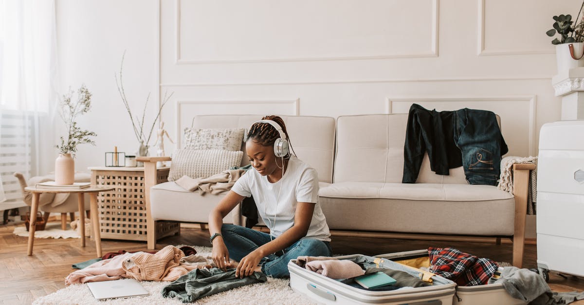 Clothes to pack for June in Geneve? - A Woman Packing Clothes in a Luggage