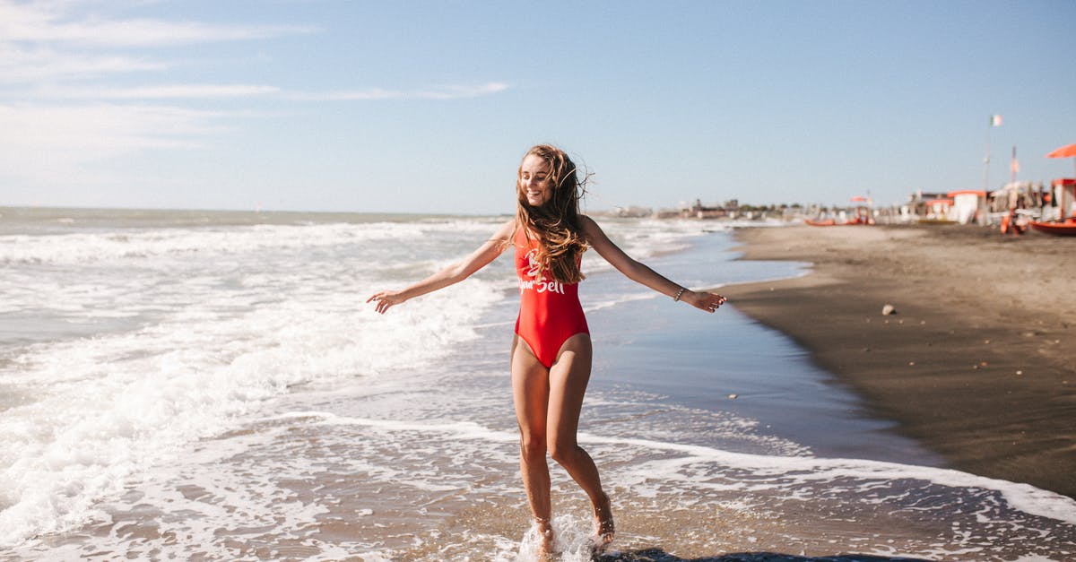 Coast Starlight delays - Woman in Red Swimsuit Standing on Beach