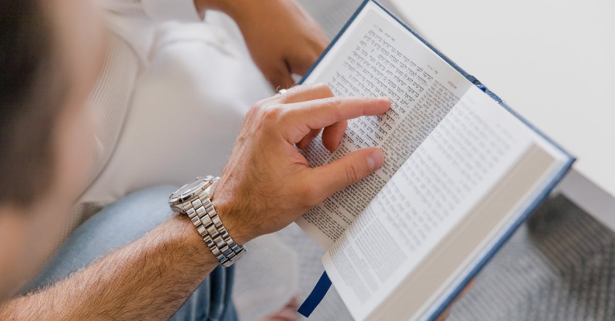 Collecting hotels.com rewards points for a third-party booking - Person in White Shirt and Blue Denim Jeans Holding White Book