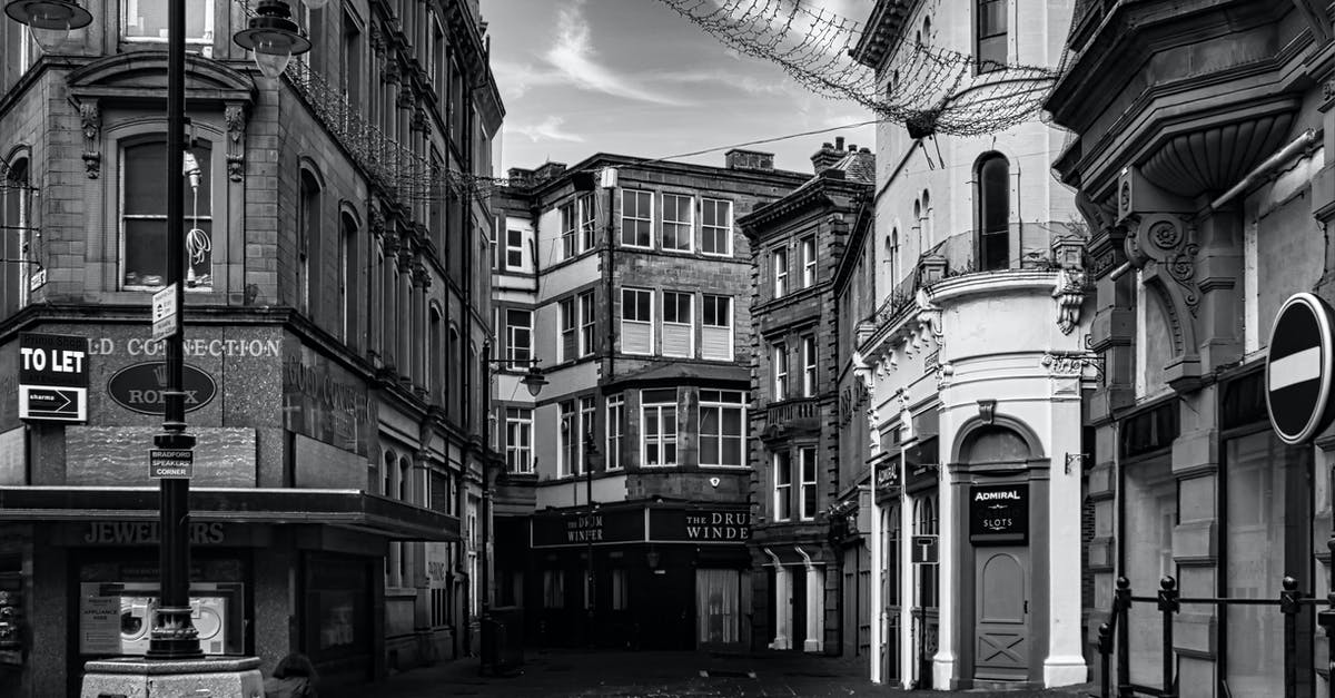 Colombian married to UK citizen - Grayscale Photo of a Street in Between Buildings