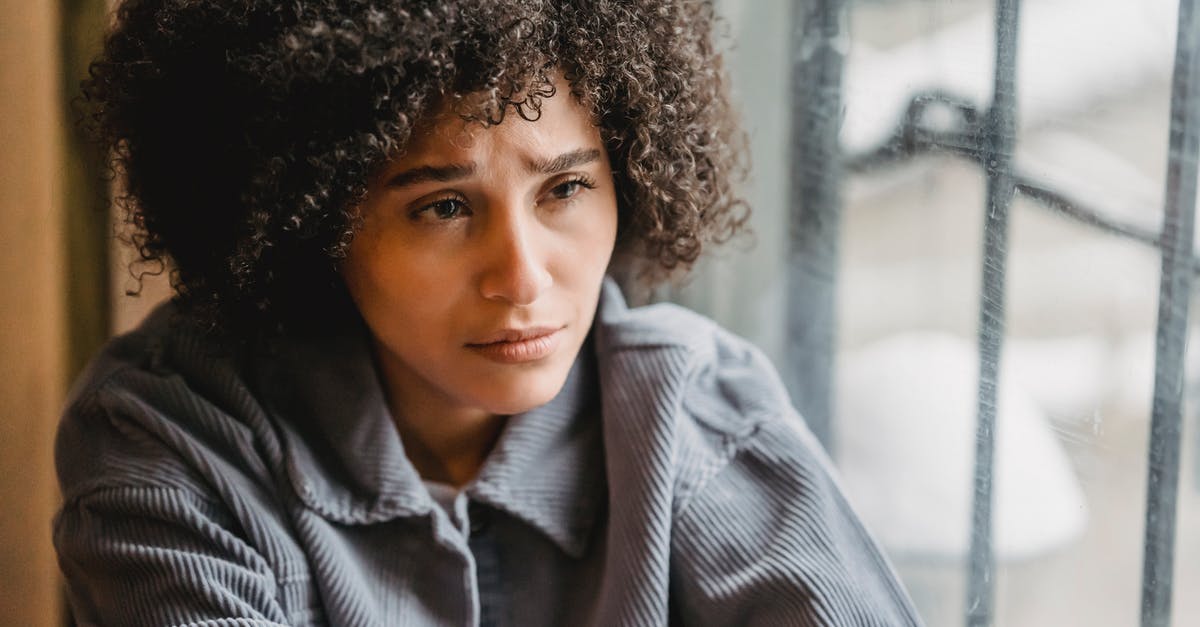 Commuting from Frankfurt to Bad Homburg - Crying helpless black woman sitting on windowsill