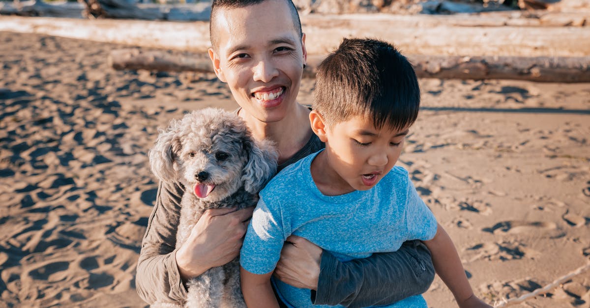 Companion Visa for family - Father Carrying His Son and Pet Dog