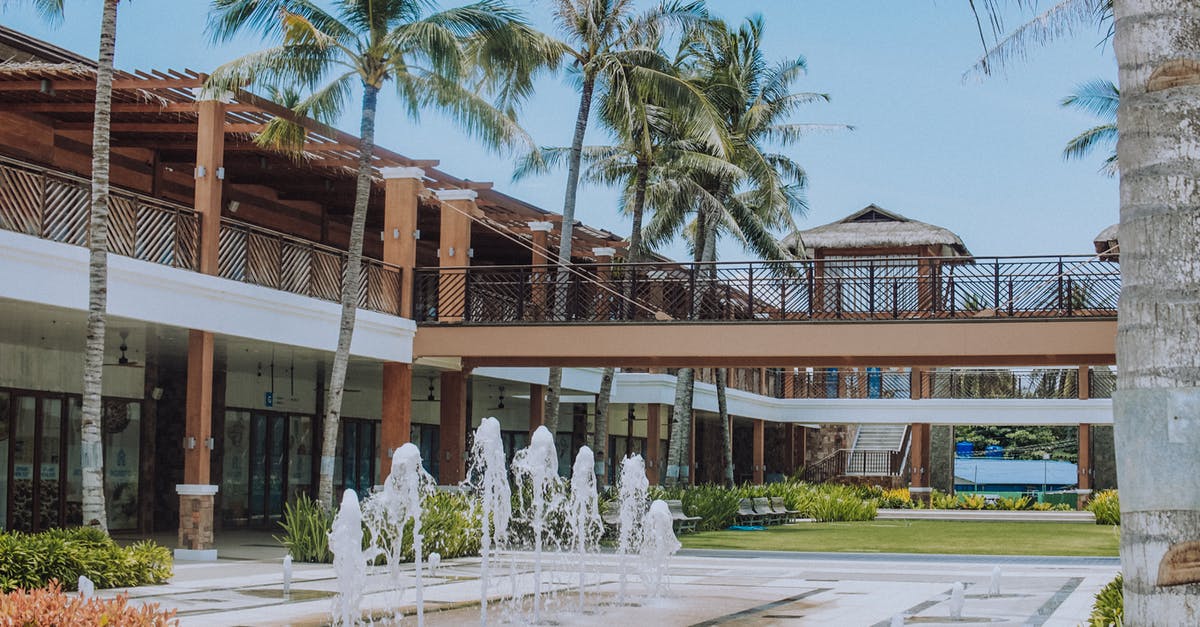 Compensation for Hotel or Travel Package - White Concrete Building Near Palm Trees