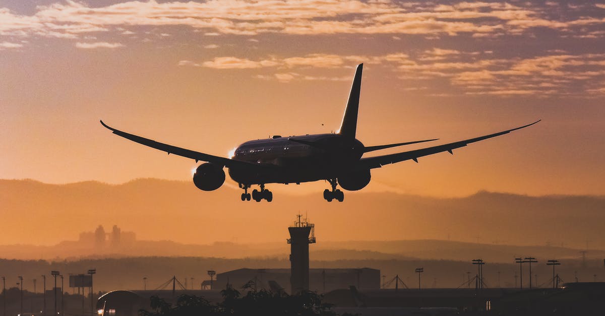 Compensation for United Airlines 5-hour flight delay - White Passenger Plane Flying over the City during Sunset