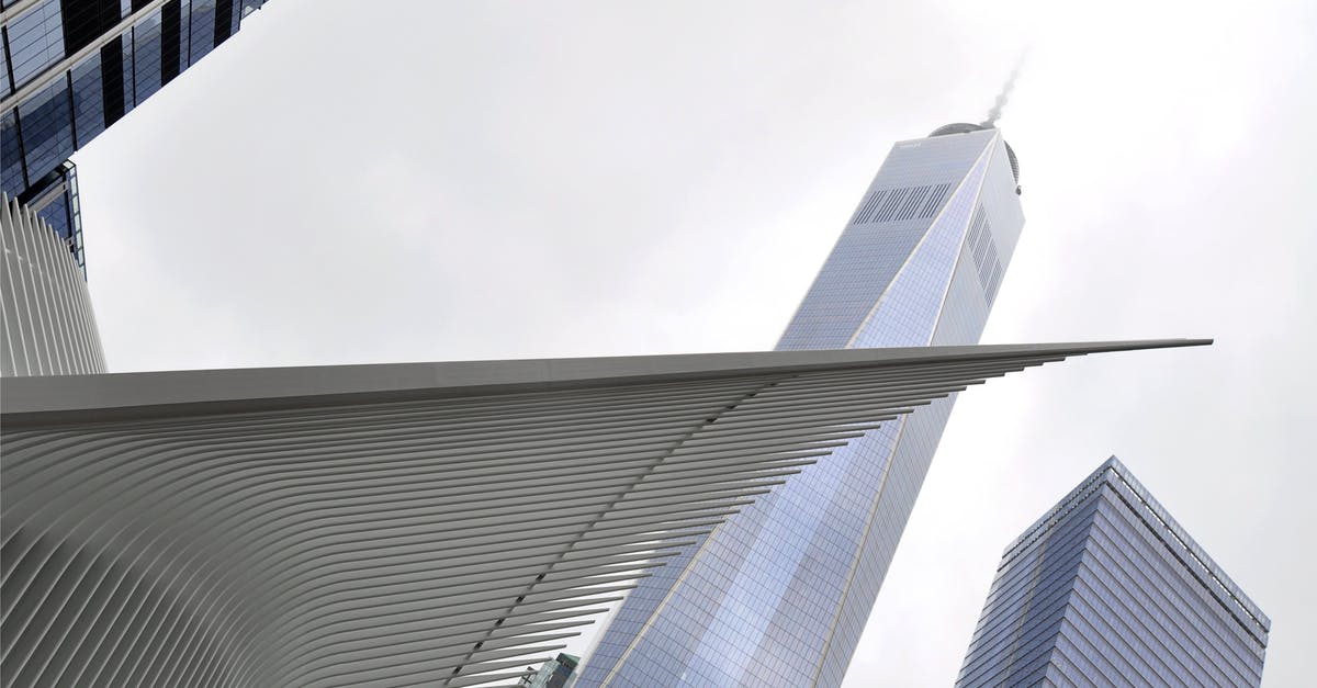 Computer/Technology oriented tourist attractions - White Concrete Tower Shape Building Near Building during Daytime