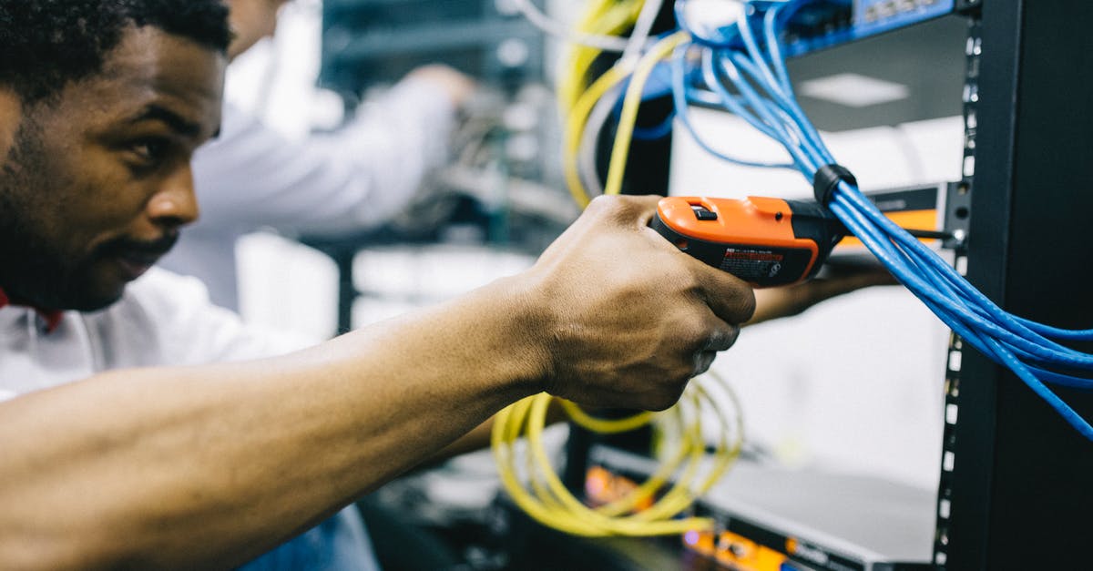 Concerns regarding UK Border Control and no job - Crop focused ethnic engineer using electric screwdriver