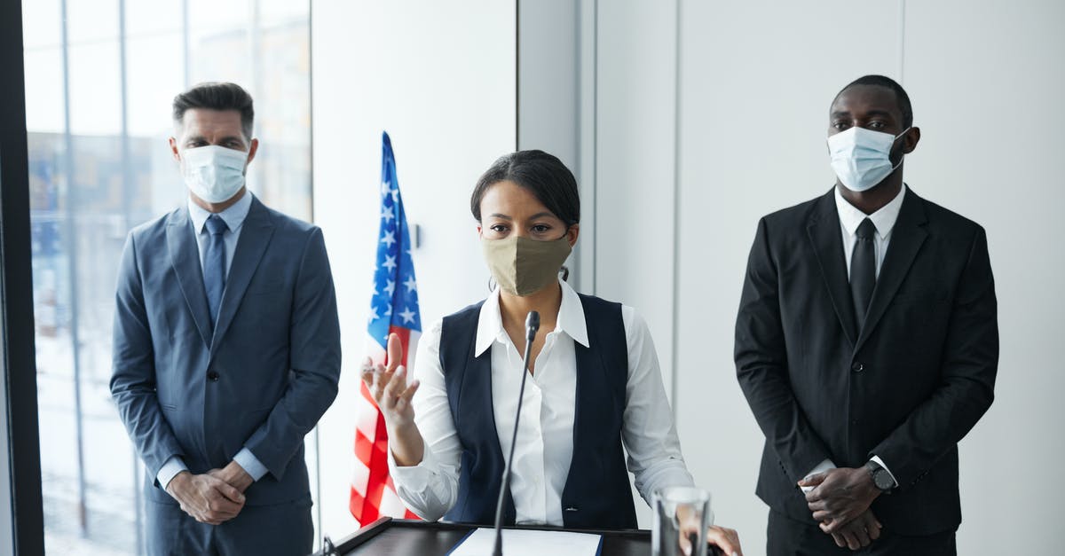 Conference in Los Angeles, visa? - Man in Black Suit Jacket Holding Orange and White Stick