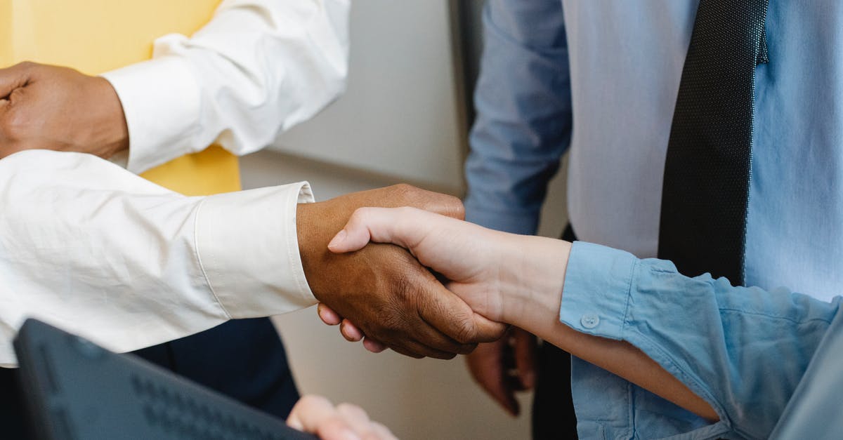 Conference in Los Angeles, visa? - Crop anonymous diverse entrepreneurs shaking hands after meeting and negotiating about new project