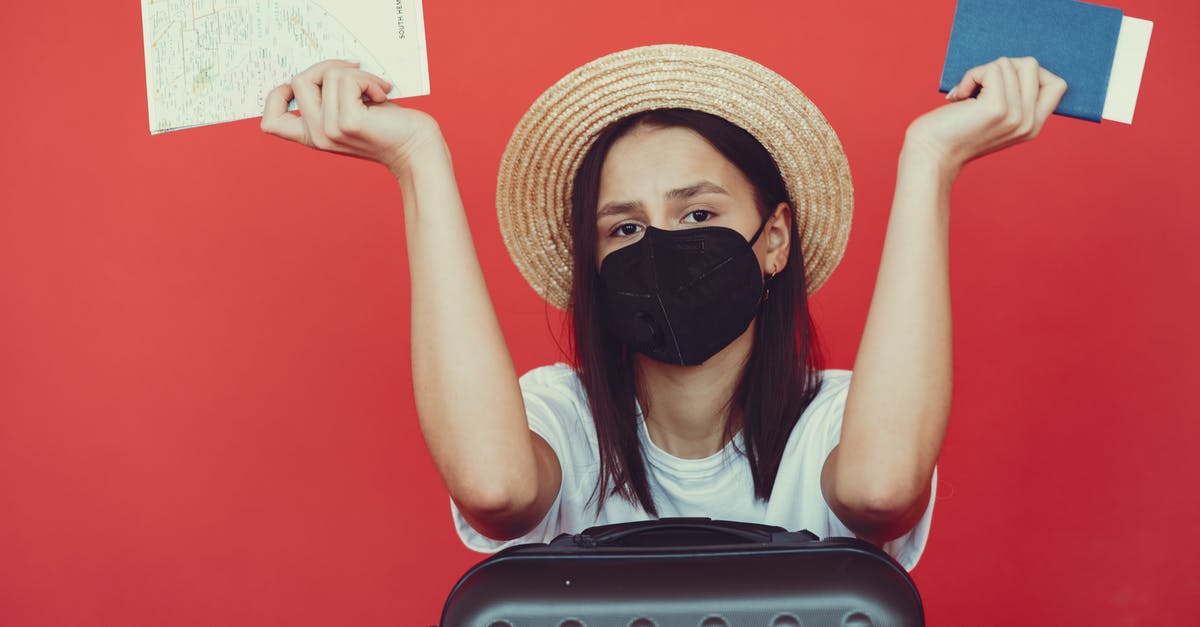 Confused about the baggage fee for different airlines - Sad woman in respiratory mask with suitcase and passport